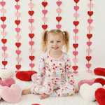 Long-sleeve baby pajama set printed with a small cupid's bow heart pattern