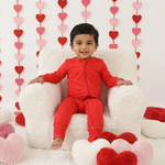 Ruby red convertible baby coverall with a full-length two-way zipper and footed legs