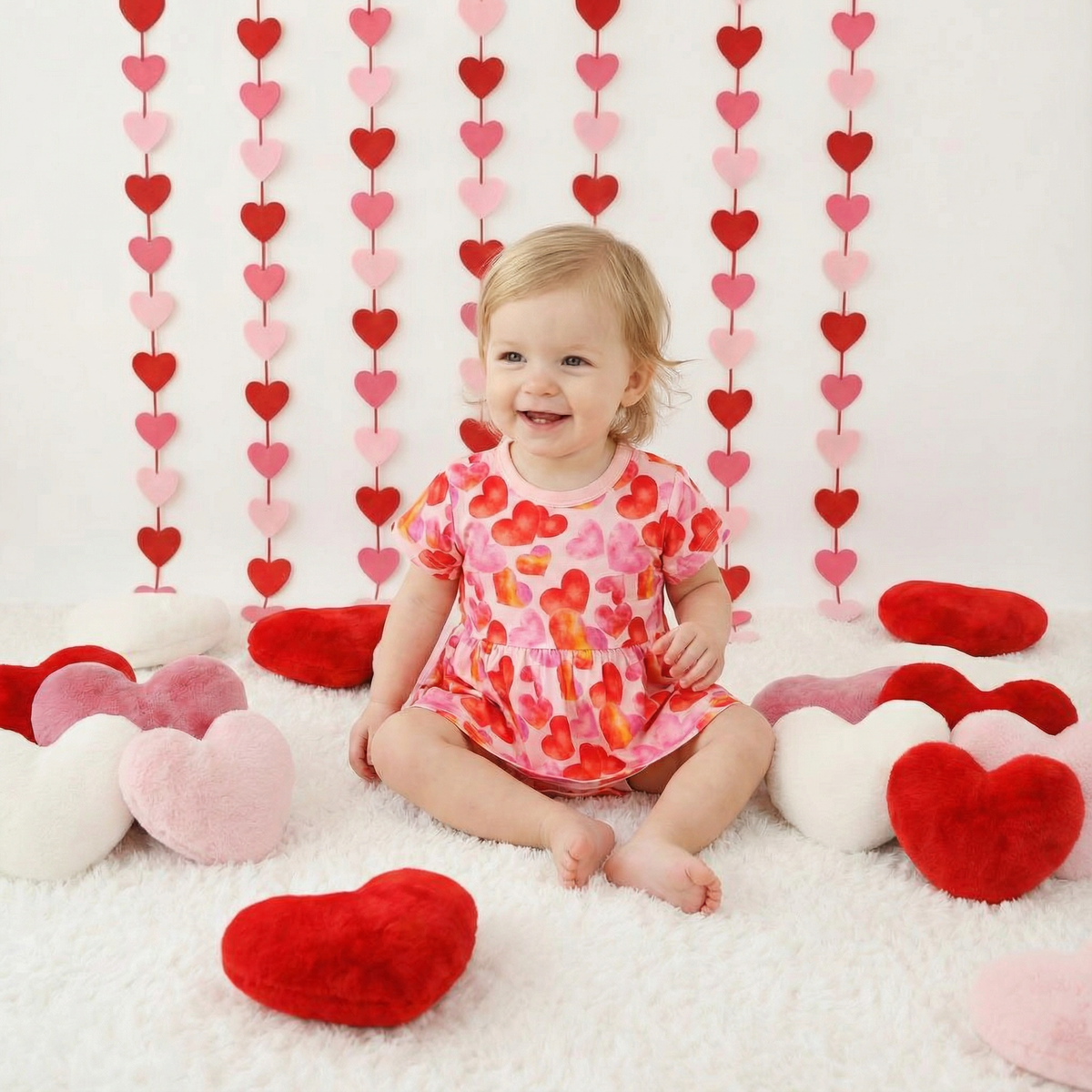 Bodysuit dress with a love hearts print, long sleeves, and snap closure at the inseam