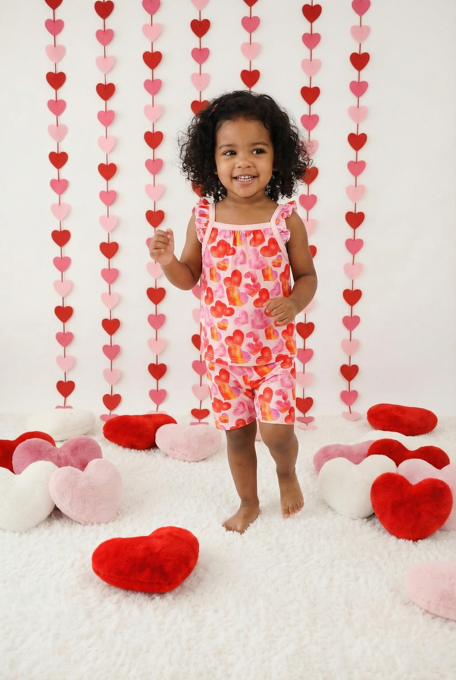 Flutter-sleeve tank top and matching shorts in a pink floral print on a white background.