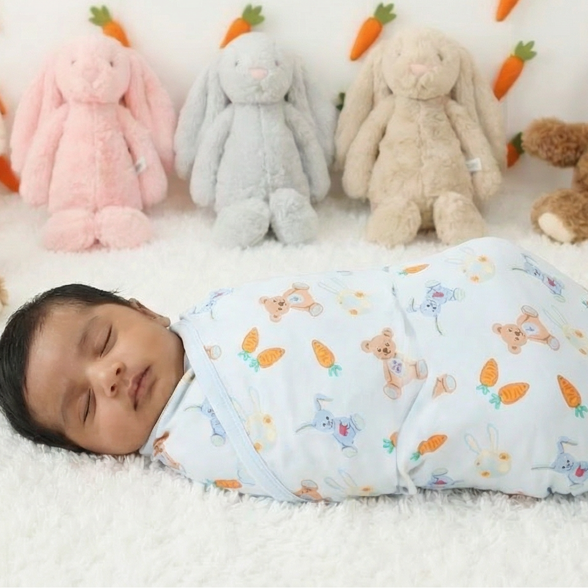 Baby swaddle blanket with a carrot print pattern spread flat