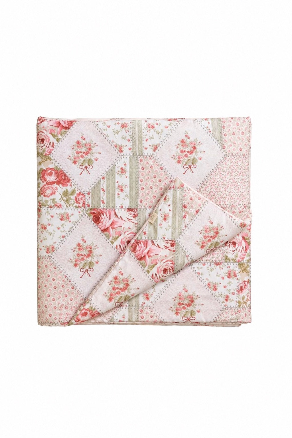 Pink patchwork quilted crib blanket with tufted stitching, shown flat.