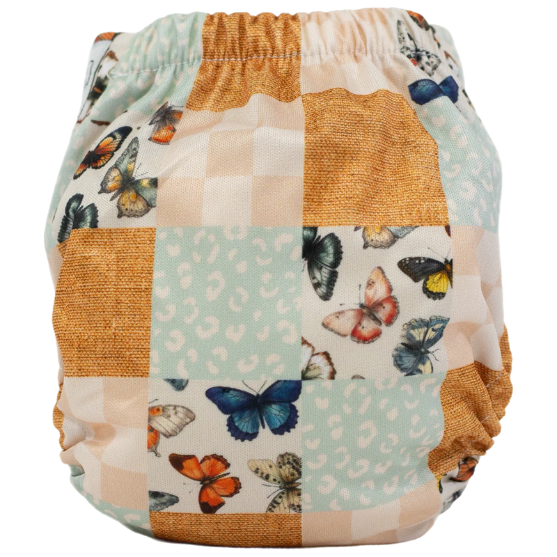 Tiny Tushies Newborn AIO Cloth Diaper with butterfly print and adjustable sizing.