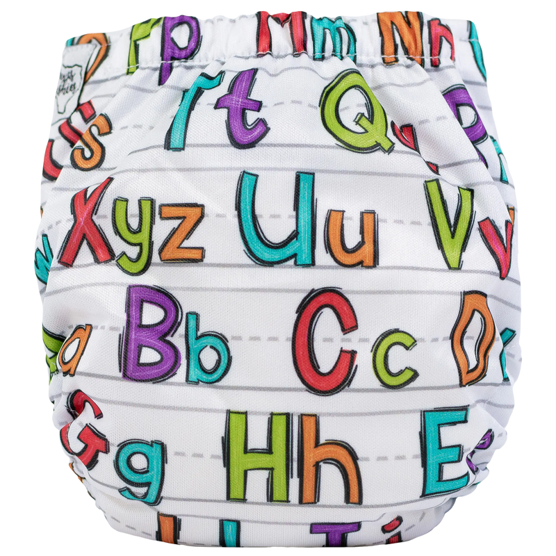 Tiny Tushies Newborn AIO cloth diaper with colorful alphabet design.