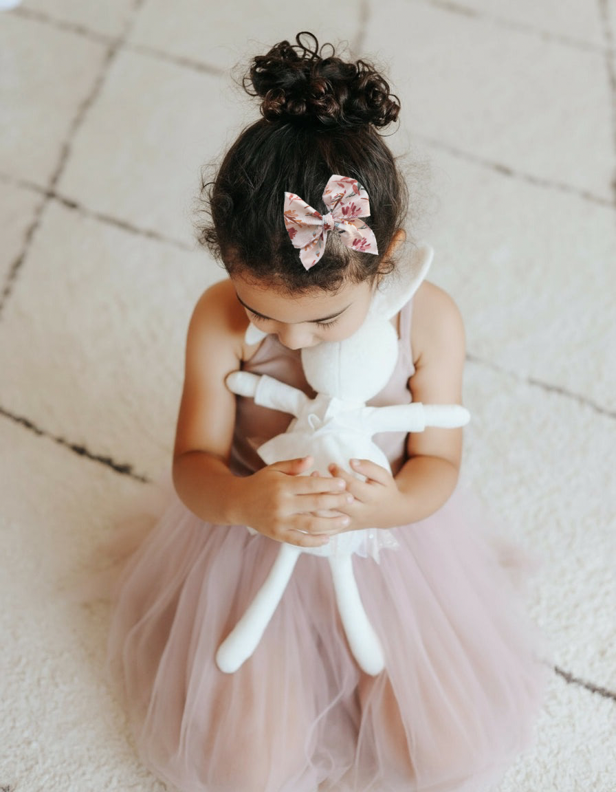 Little Mae & Co white sailor bow headband and clip on a baby, suitable for newborns to girls.