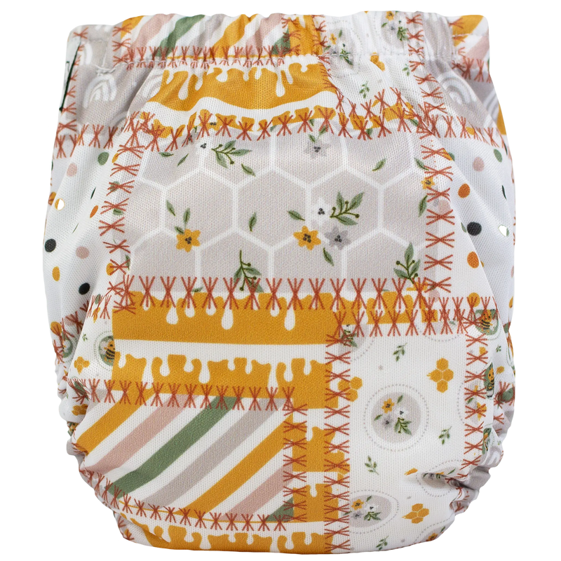 Tiny Tushies Newborn AIO Cloth Diaper with colorful printed design.