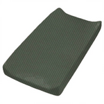 Close-up of a soft, organic moss green ribbed changing pad cover on a baby changing table.