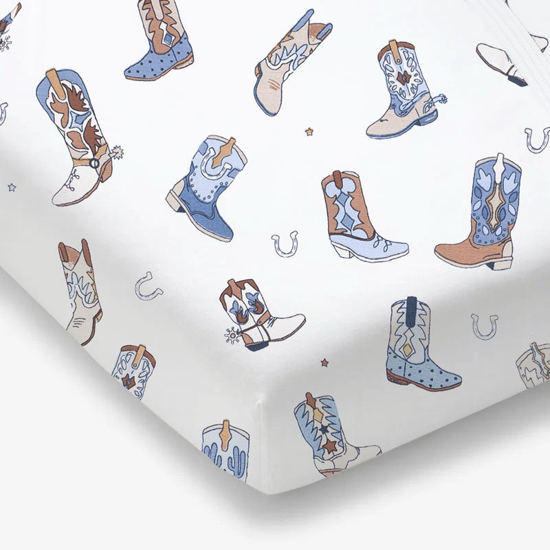 Crib sheet with a Western cowboy boot print in soft neutral tones on a fitted crib mattress