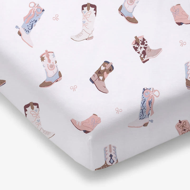 Crib sheet with a Western cowboy-boot print, fitted over a standard crib mattress