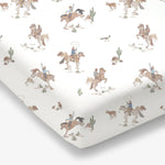 Crib sheet with a horse wrangler print on a standard crib mattress