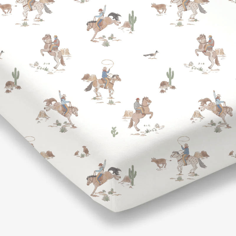 Crib sheet with a horse wrangler print on a standard crib mattress