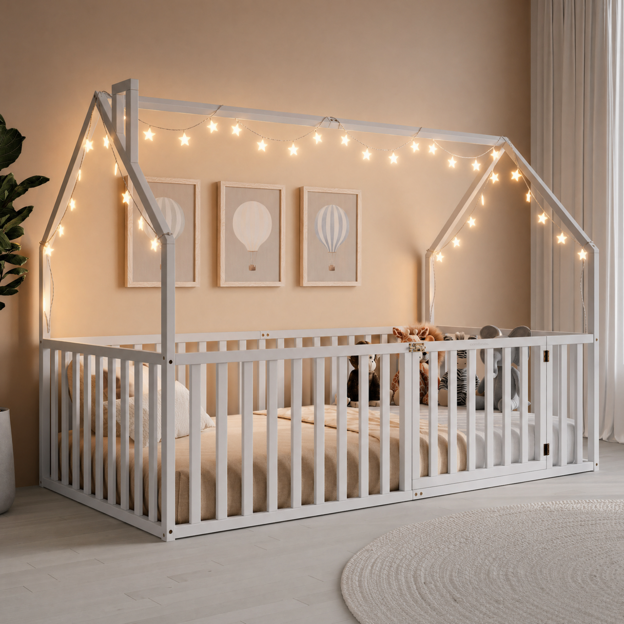 White wooden house-shaped twin floor bed with gated slat sides and open peaked-roof frame