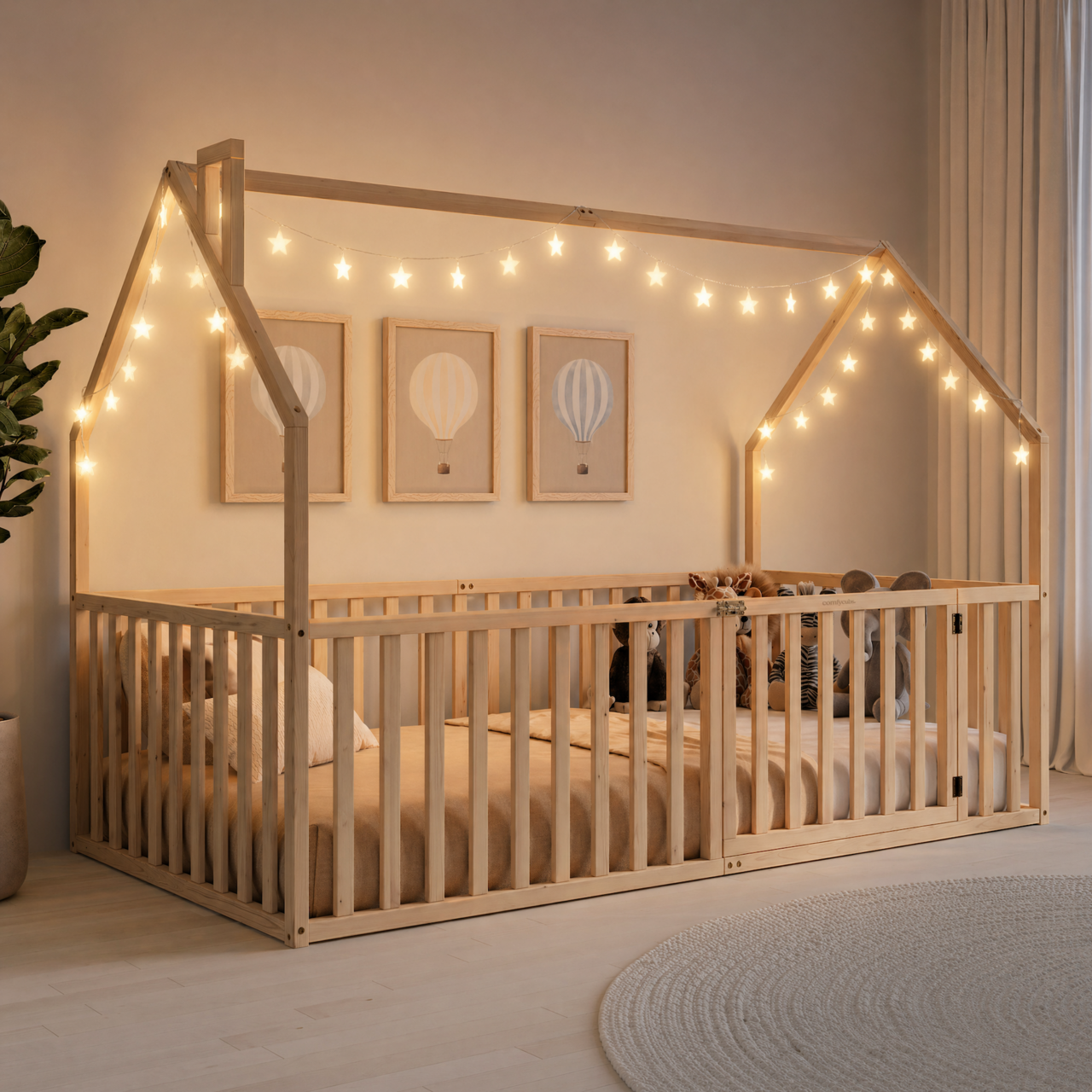 Natural wood house-shaped twin floor bed with peaked open-top frame, vertical slats, and a gated entry.