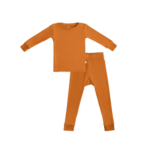 Rust-colored toddler pajama set with long-sleeve top and matching pants