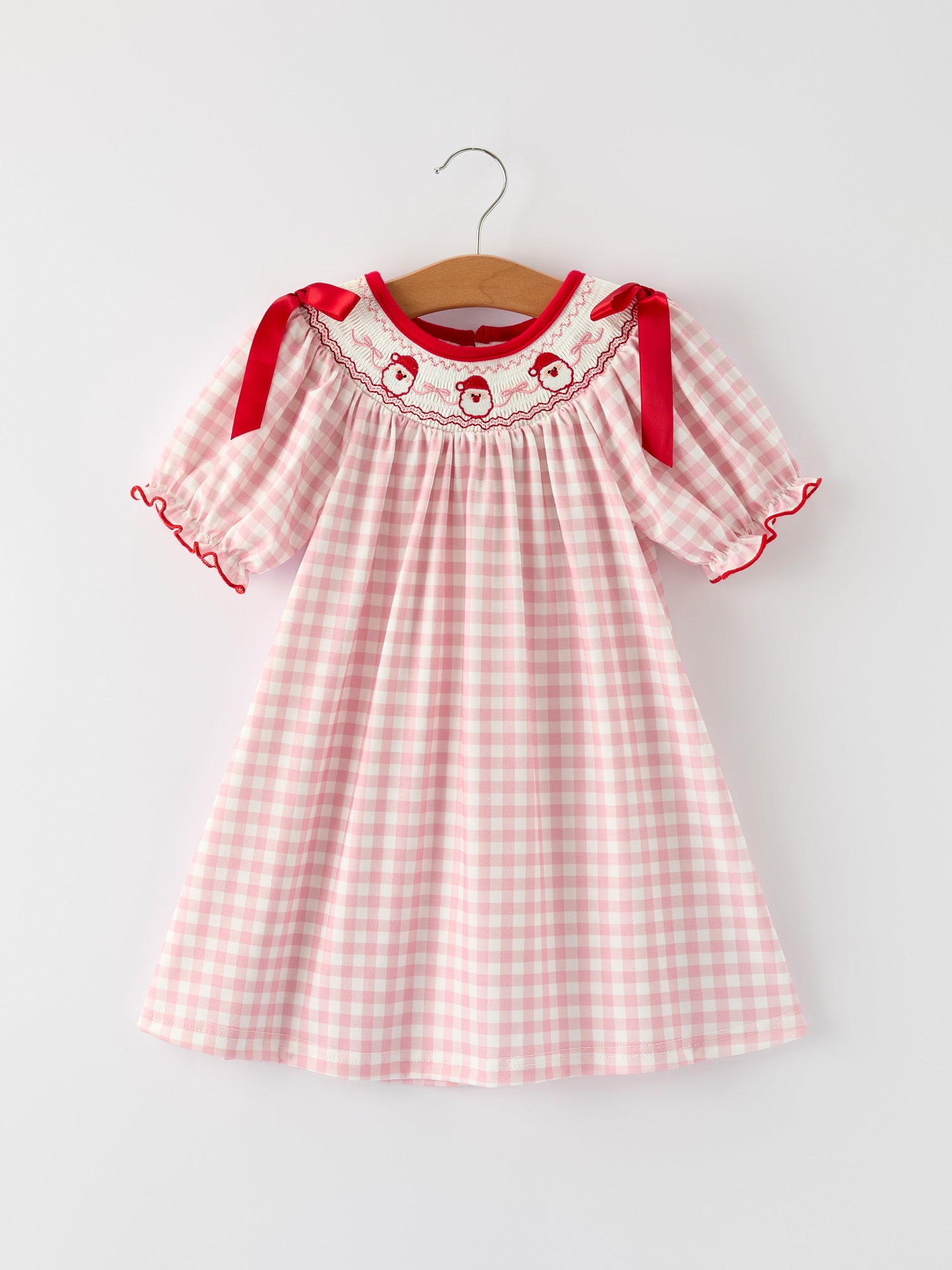 Pink gingham girls Christmas dress with Santa embroidery on the bodice and a red satin ribbon tie