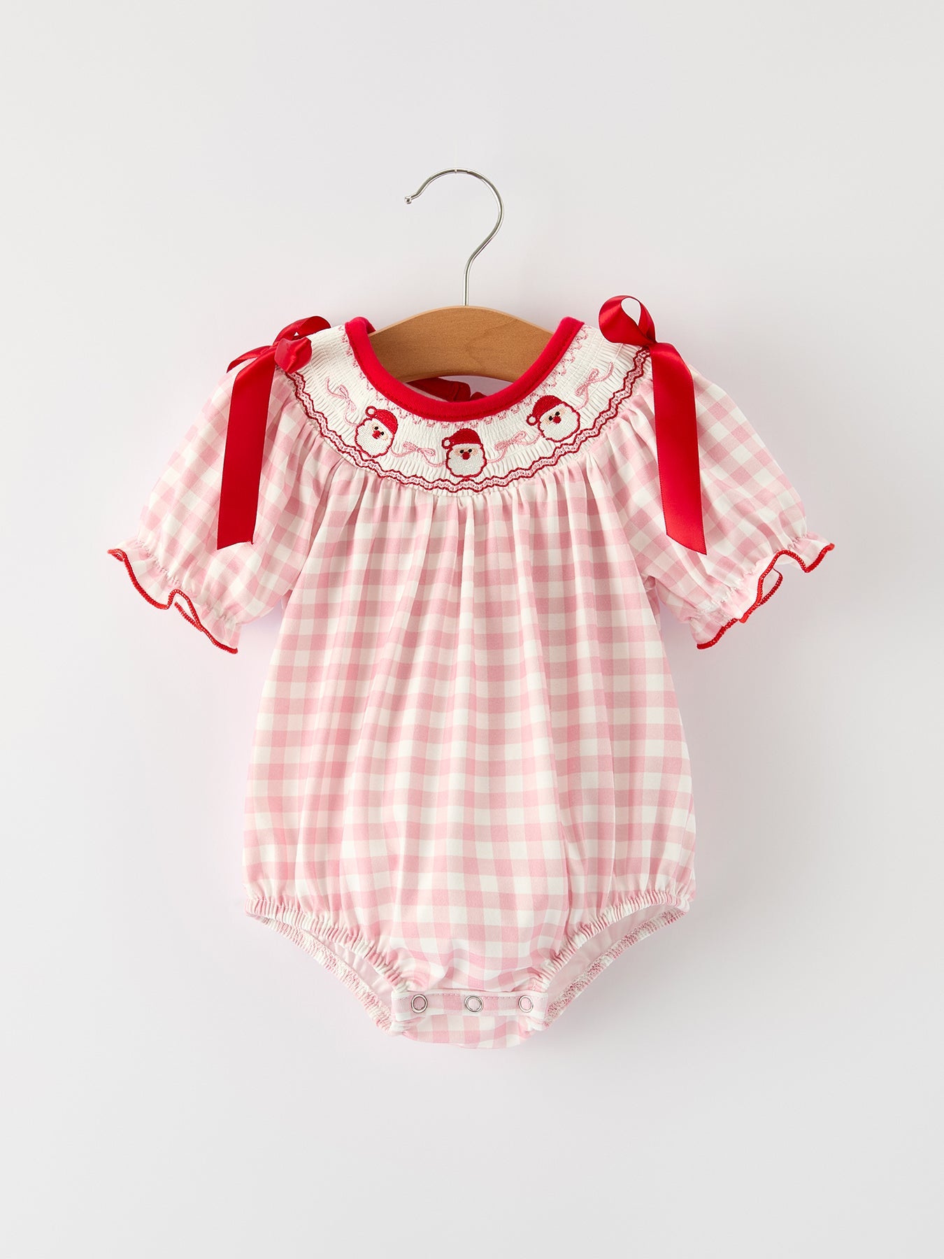 Pink gingham baby girls romper with Santa embroidery on the front and a red satin ribbon tie