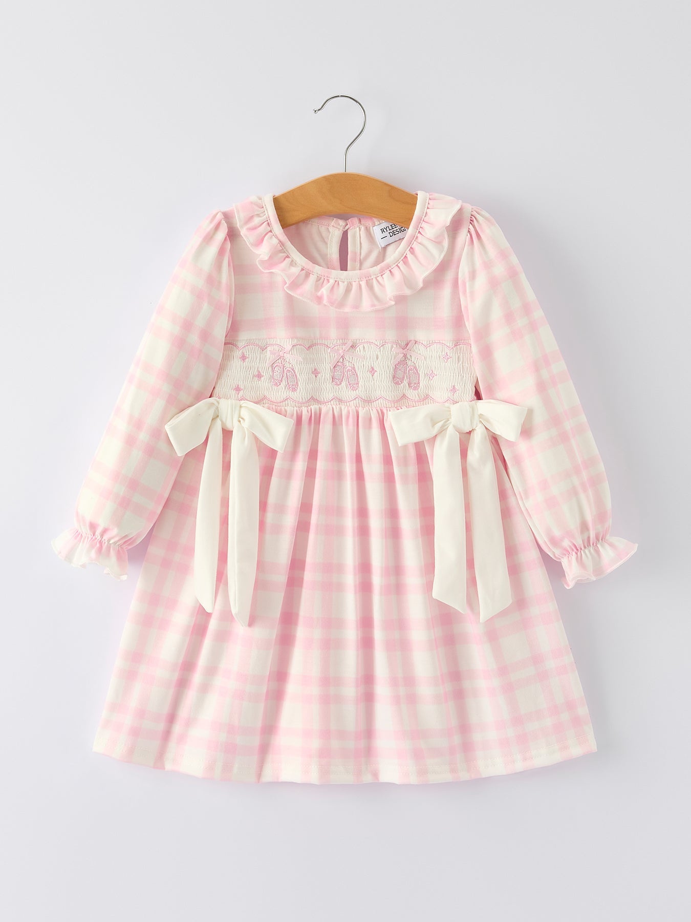 Long sleeve pink plaid dress with ballet shoe embroidery and ruffled details