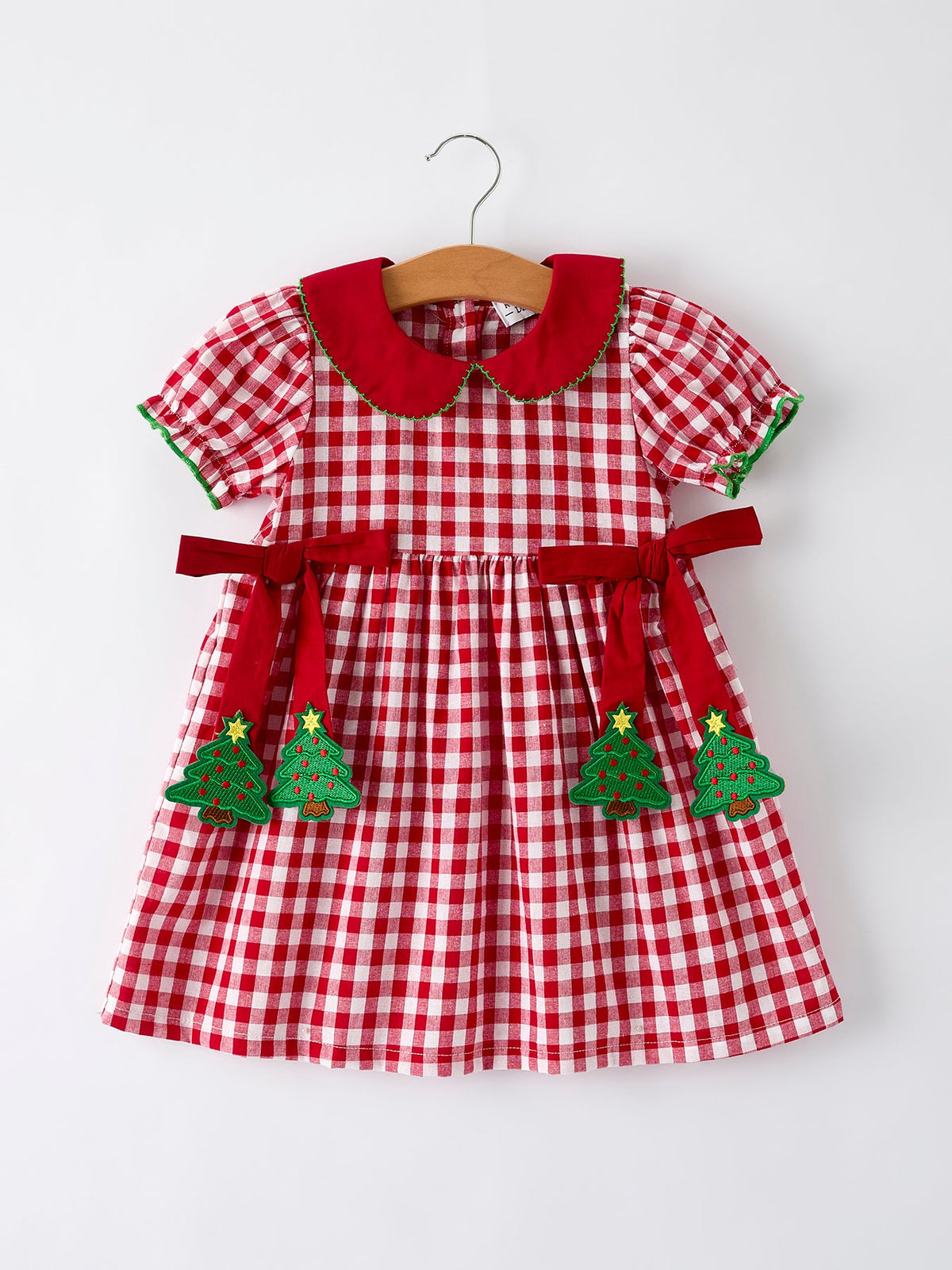 Girls' red plaid Christmas dress with tree-shaped bow accents