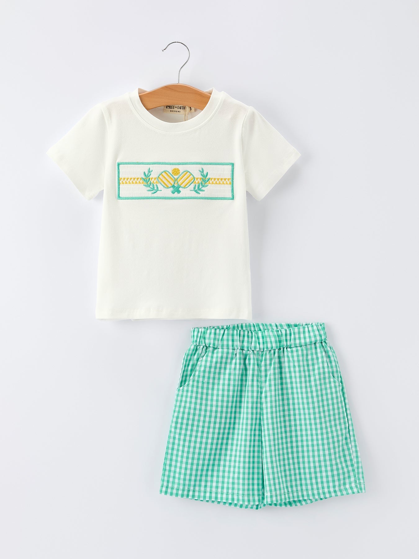 Boys two-piece shorts set in green gingham with pickleball embroidery and smocked front top.