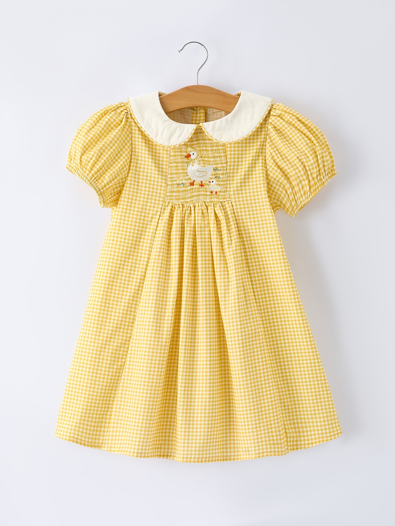 Rylee Faith Designs yellow goose embroidered smocked plaid dress for baby girls.