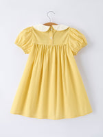 Rylee Faith Designs yellow goose embroidered smocked plaid dress.