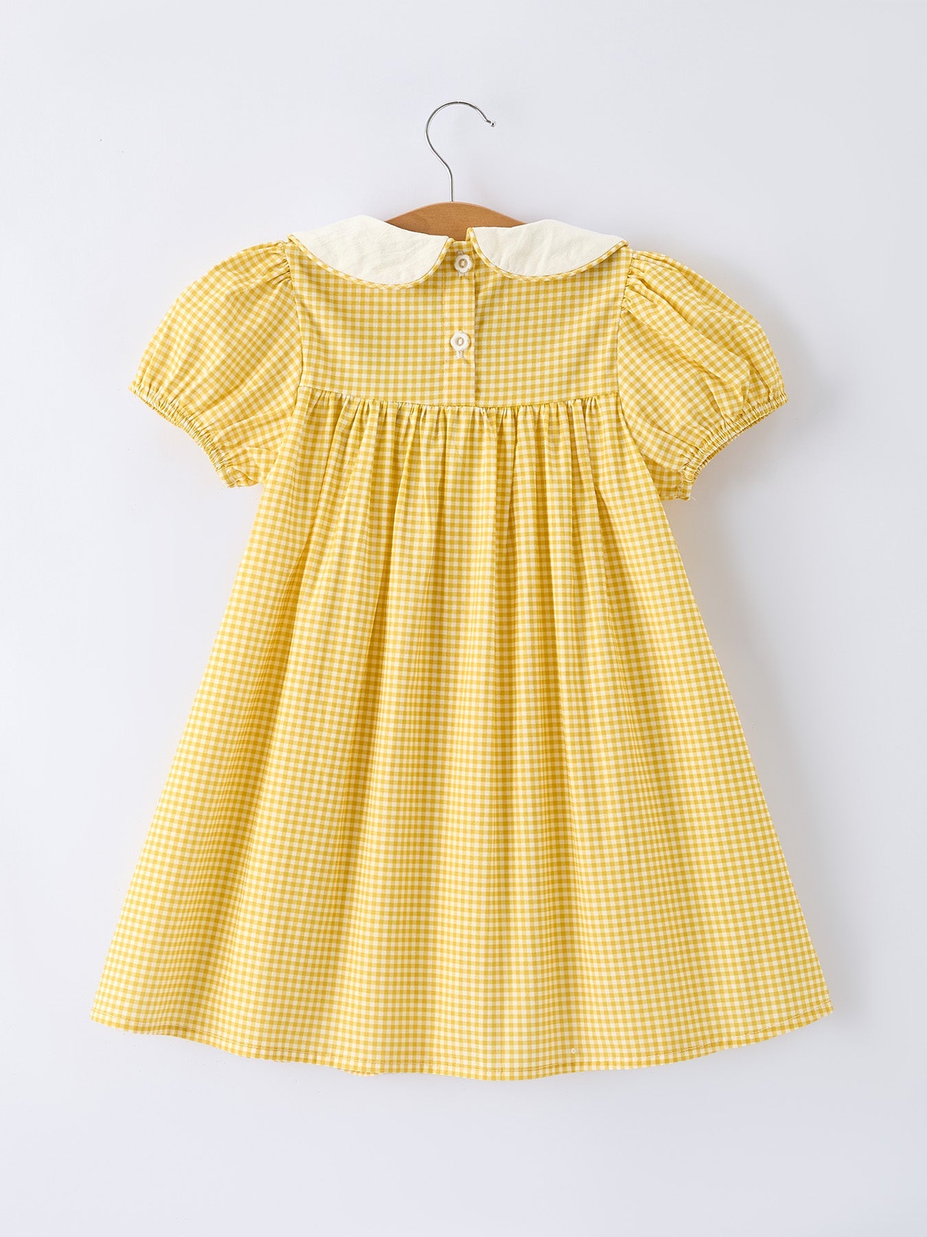Rylee Faith Designs yellow goose embroidered smocked plaid dress.