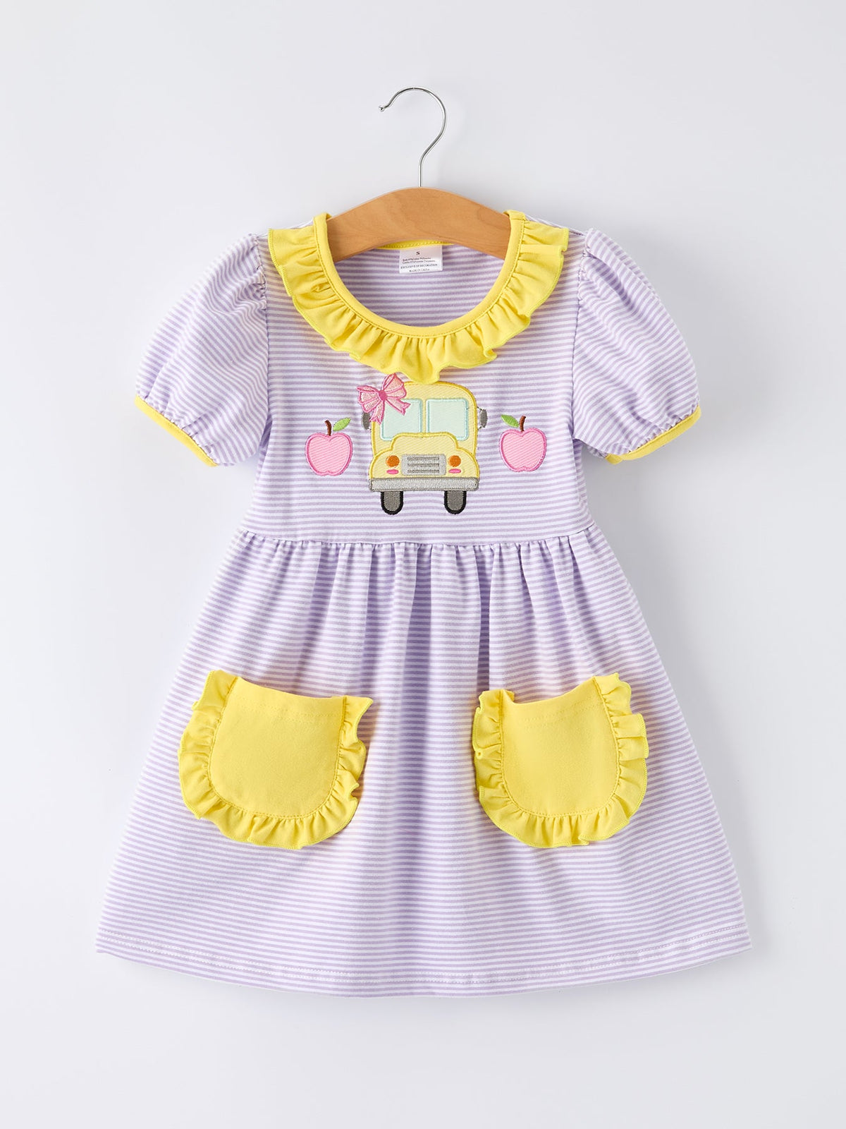 Rylee Faith Designs girls' back to school bus applique dress with ruffle pockets and short sleeves.