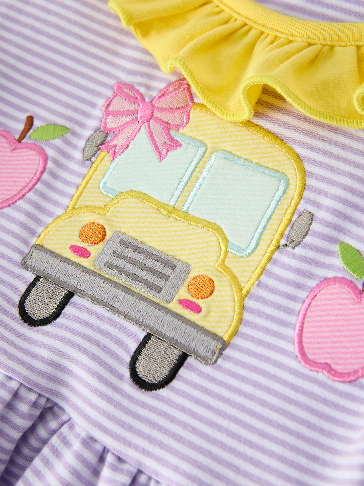Rylee Faith Designs girls' back to school bus applique dress with ruffle pockets and short sleeves.