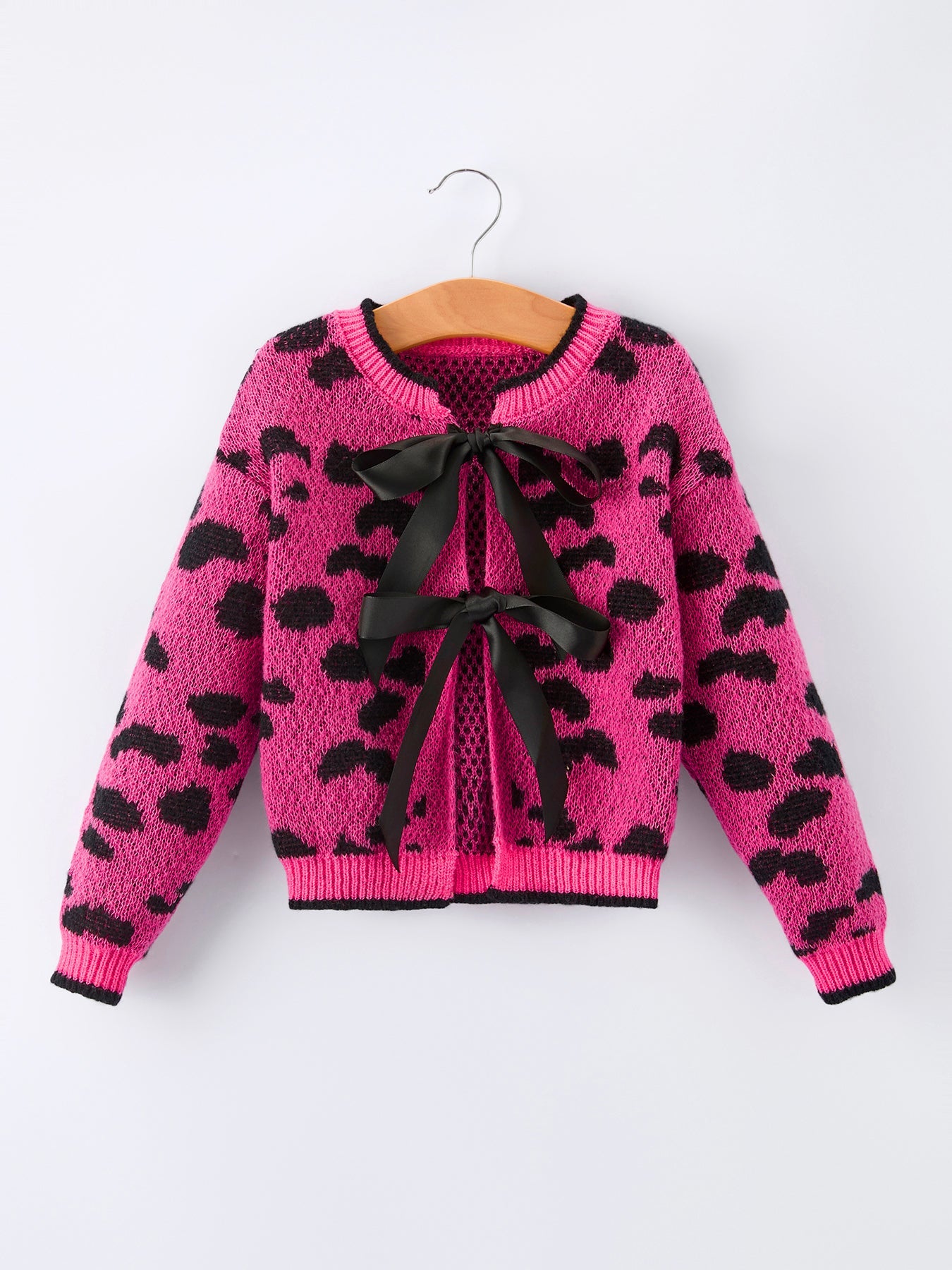 Girls knit cardigan in pink leopard print with black bow tie closures down the front.