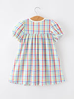 Young girl wearing a Rylee Faith Designs plaid dog print twirl dress, perfect for back to school.