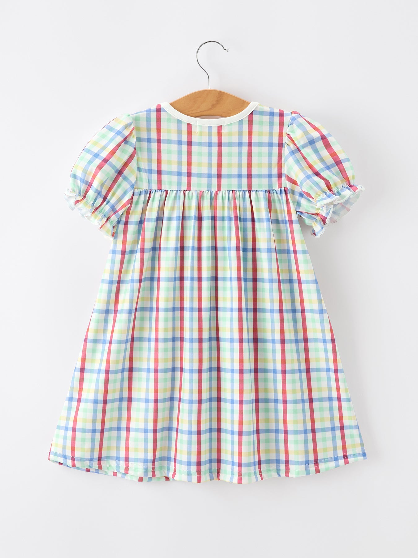 Young girl wearing a Rylee Faith Designs plaid dog print twirl dress, perfect for back to school.