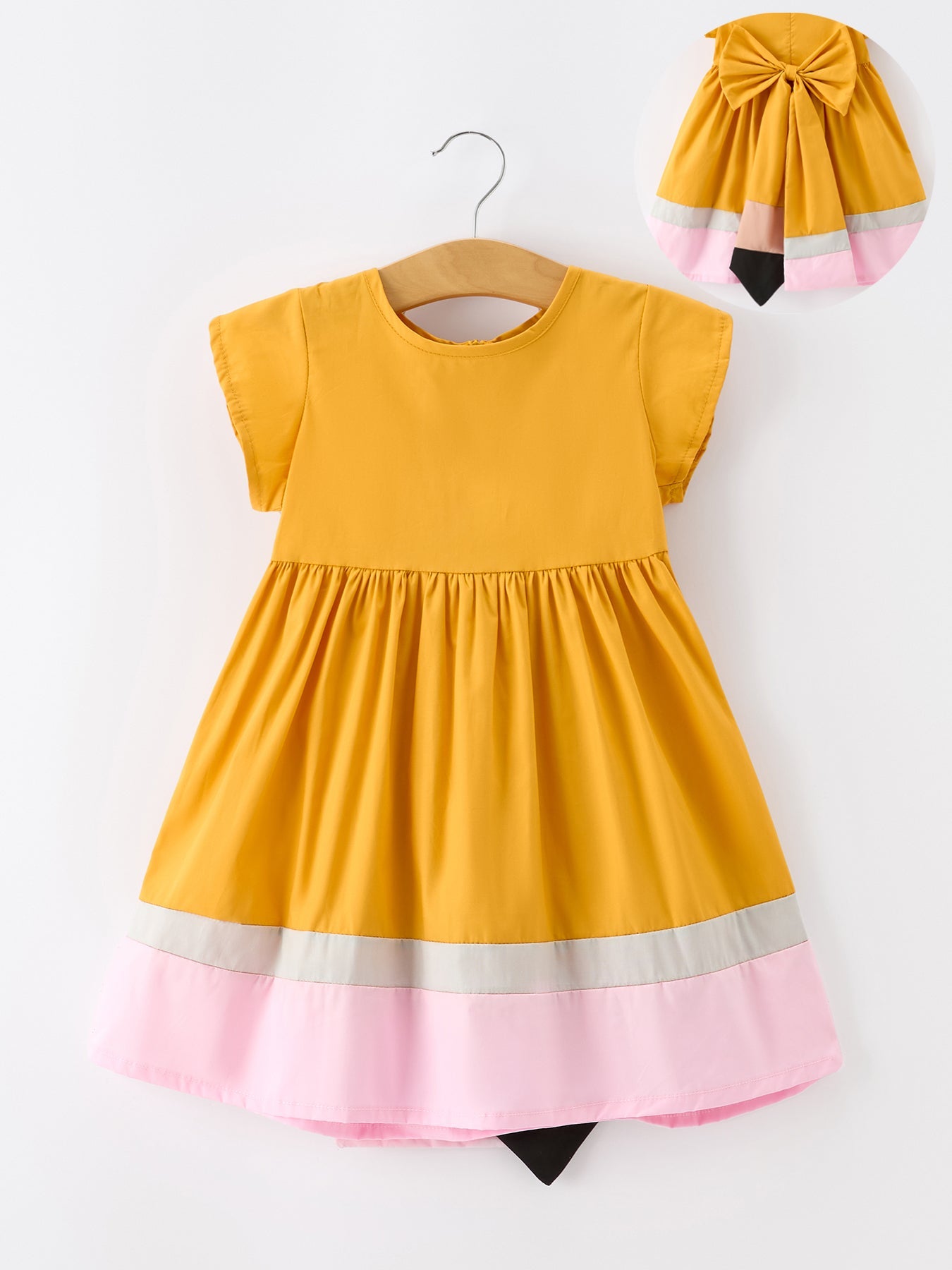 Girls' color block dress with a pencil-inspired design in mustard, pink, and neutral tones.