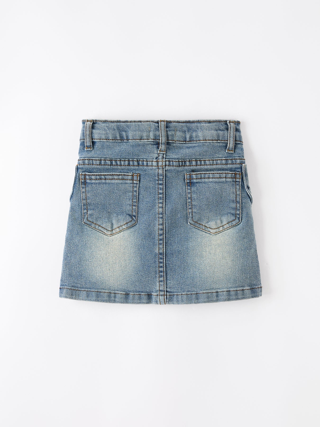 Toddler girl wearing Rylee Faith Designs denim bow skirt with cute side bow details, smiling.