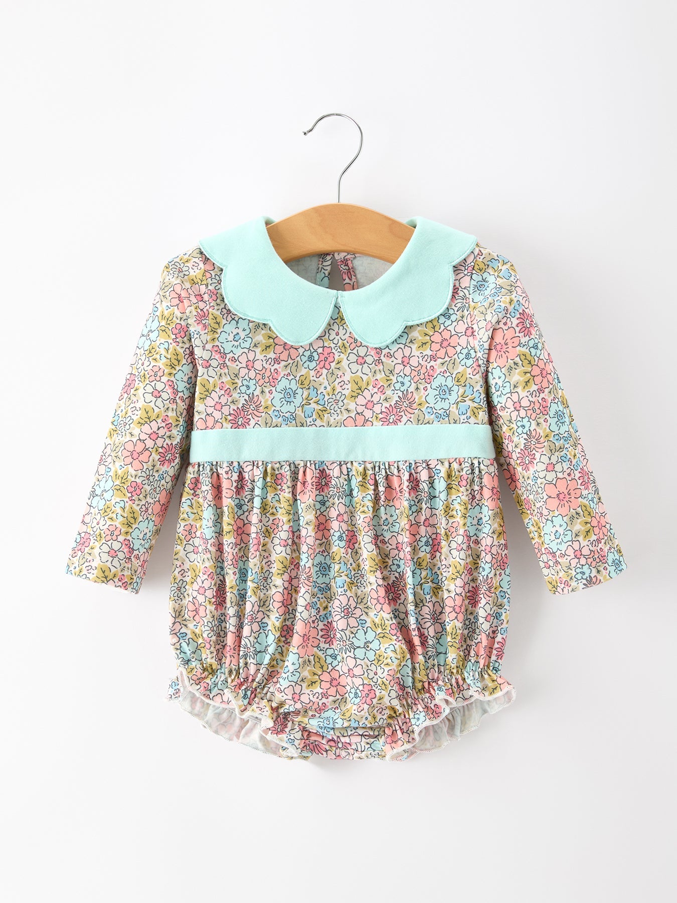 Baby bubble romper in pastel floral print with a mint contrast petals collar and ruffle leg openings.