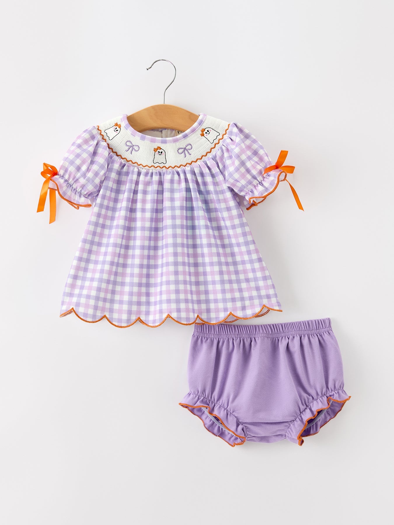 Girls' two-piece bloomer set in lavender plaid with embroidered ghosts, puff sleeves, orange bows, and ruffle bloomers.