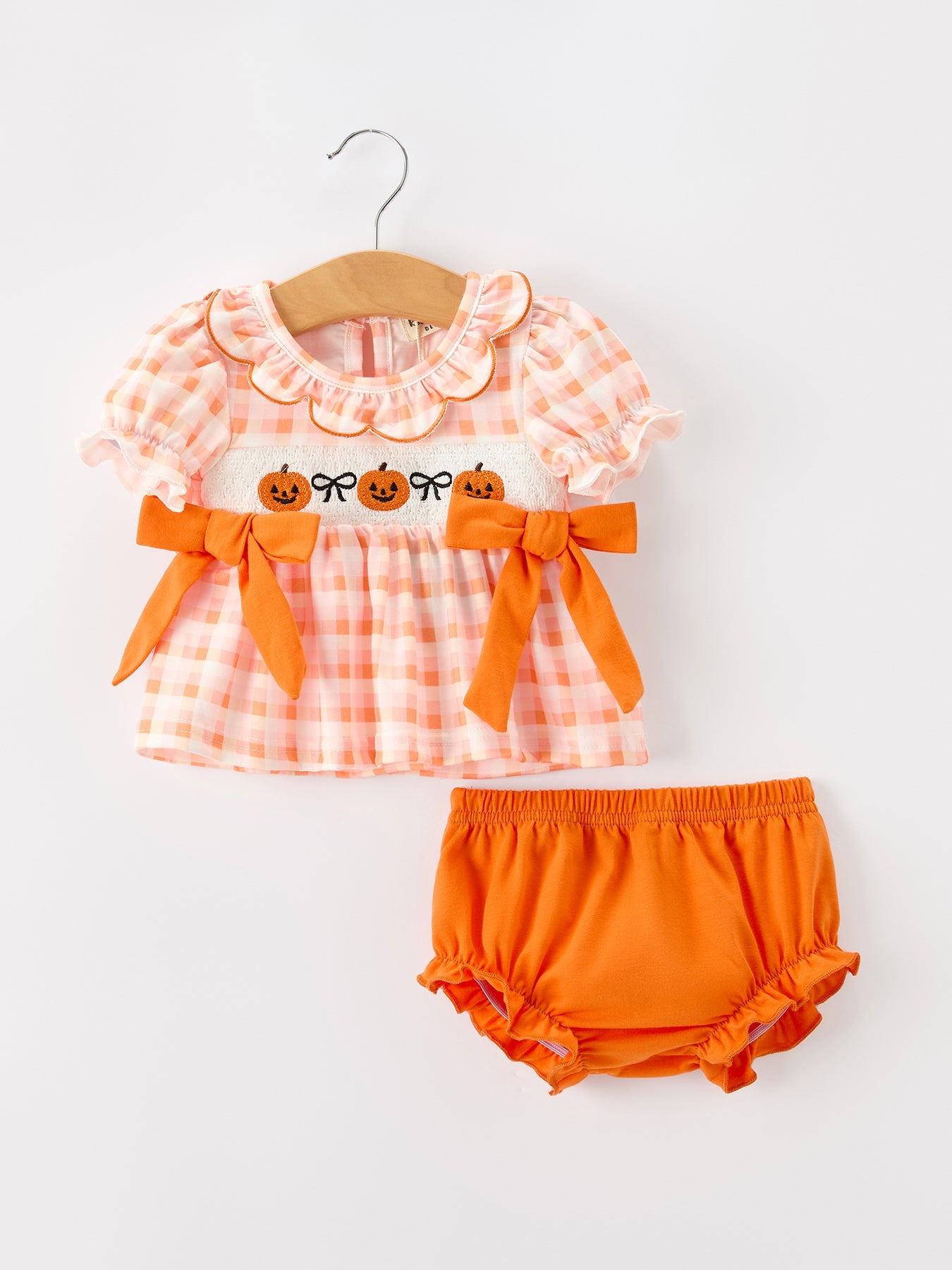 Girls bloomer set in orange gingham with embroidered pumpkins, puff sleeves, ruffle collar, side bows, and matching ruffle