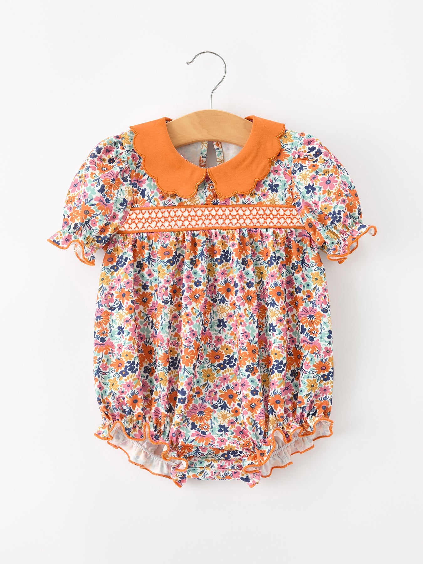 Girls bubble romper in colorful fall floral print with puff sleeves and a contrasting petals collar.