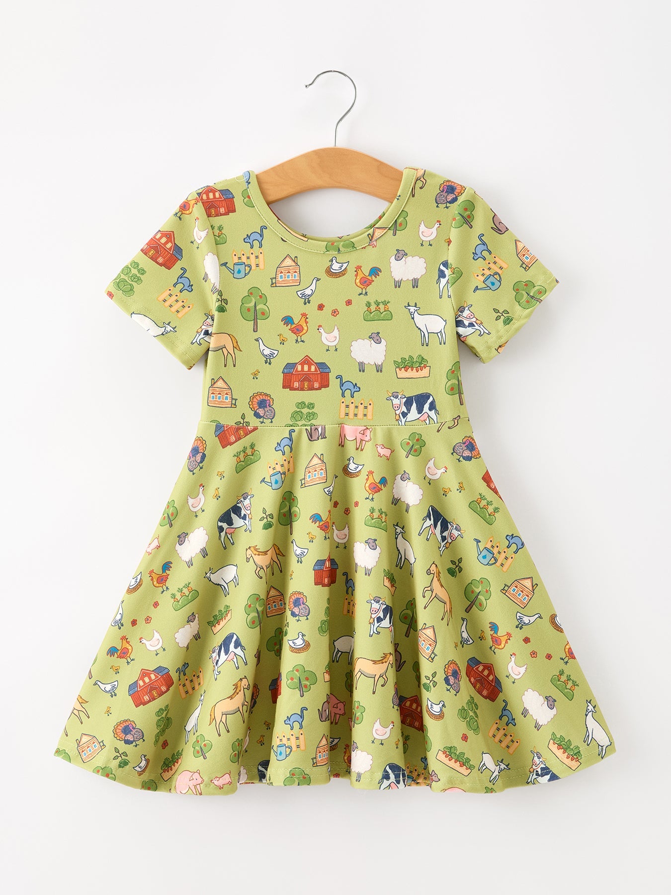 Girls twirl dress with a farm animal print of barns, cows, sheep, goats, and horses on pastel green.