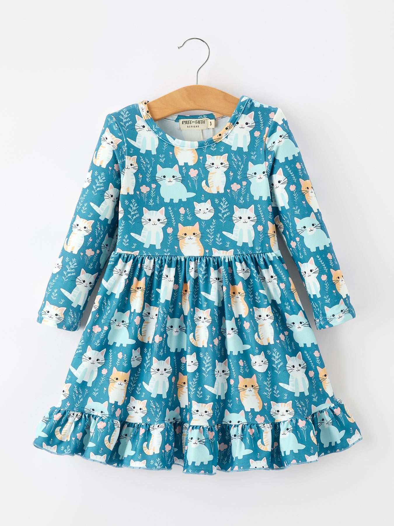 Long sleeve girls dress with allover cat print and a ruffle hem in a flowy silhouette