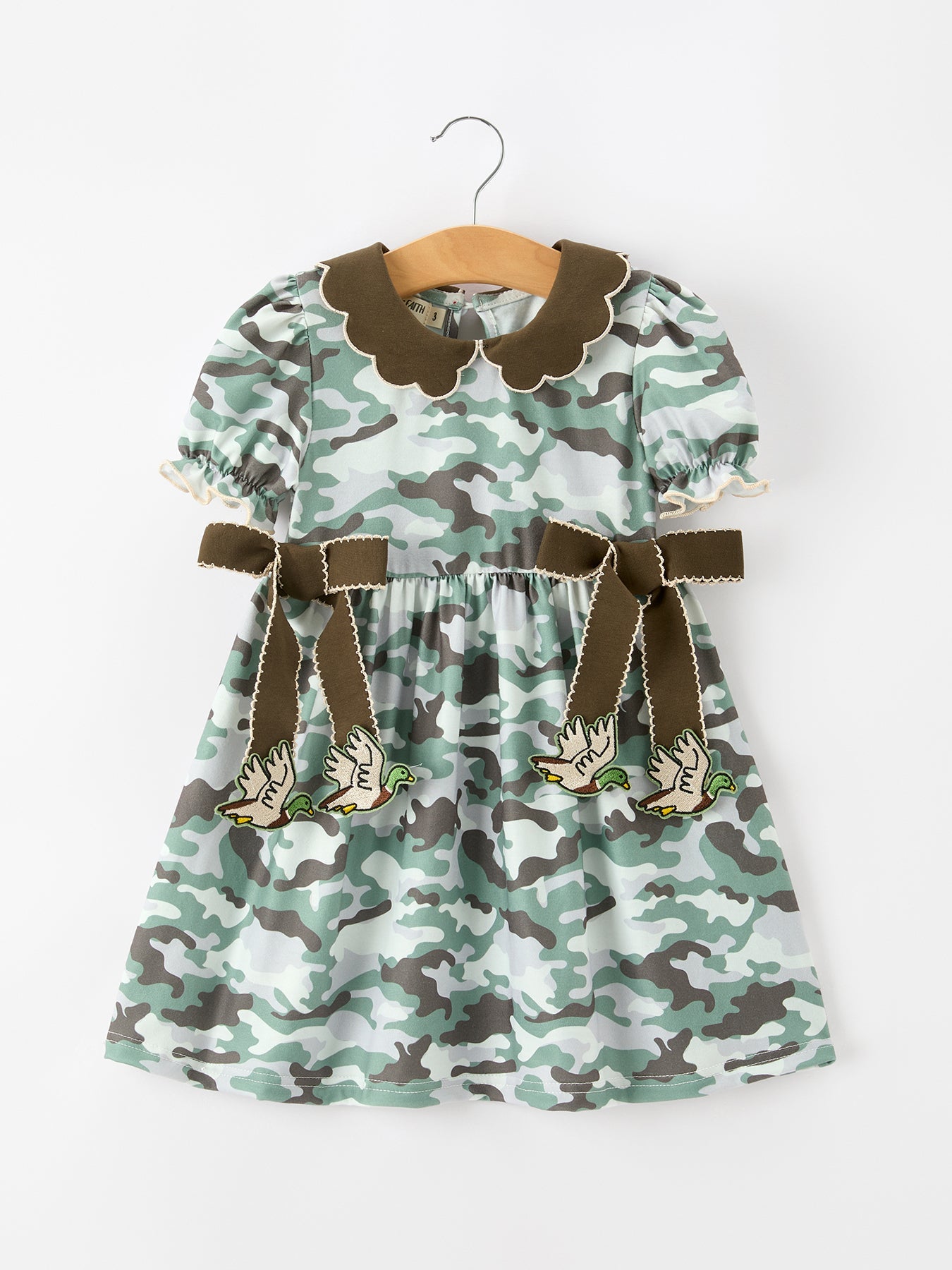 Girls twirl dress in camouflage print with puff sleeves, bow accents, and layered ruffle skirt