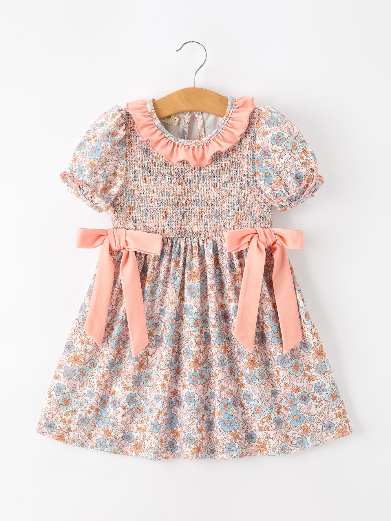 Fall floral girls dress with smocked bodice, ruffle neckline, and bow accents.