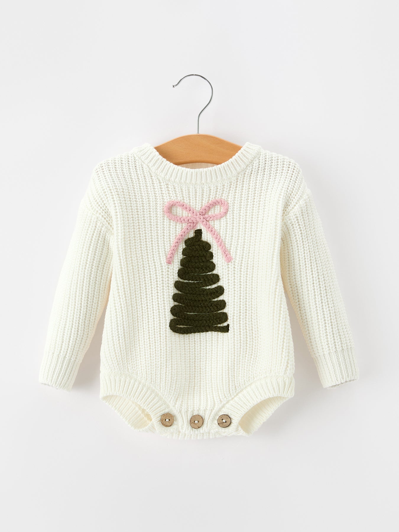 Long sleeve girls knit romper with a Christmas tree design, bow detail, and bottom button closures