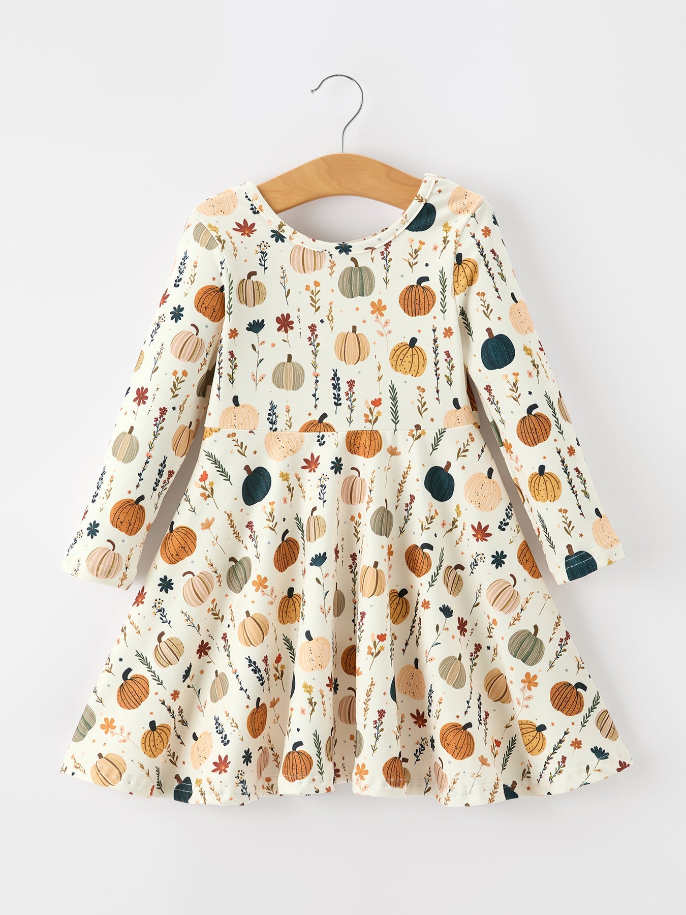 Long-sleeve girls twirl dress with orange pumpkins and small floral print, flared flowy skirt.