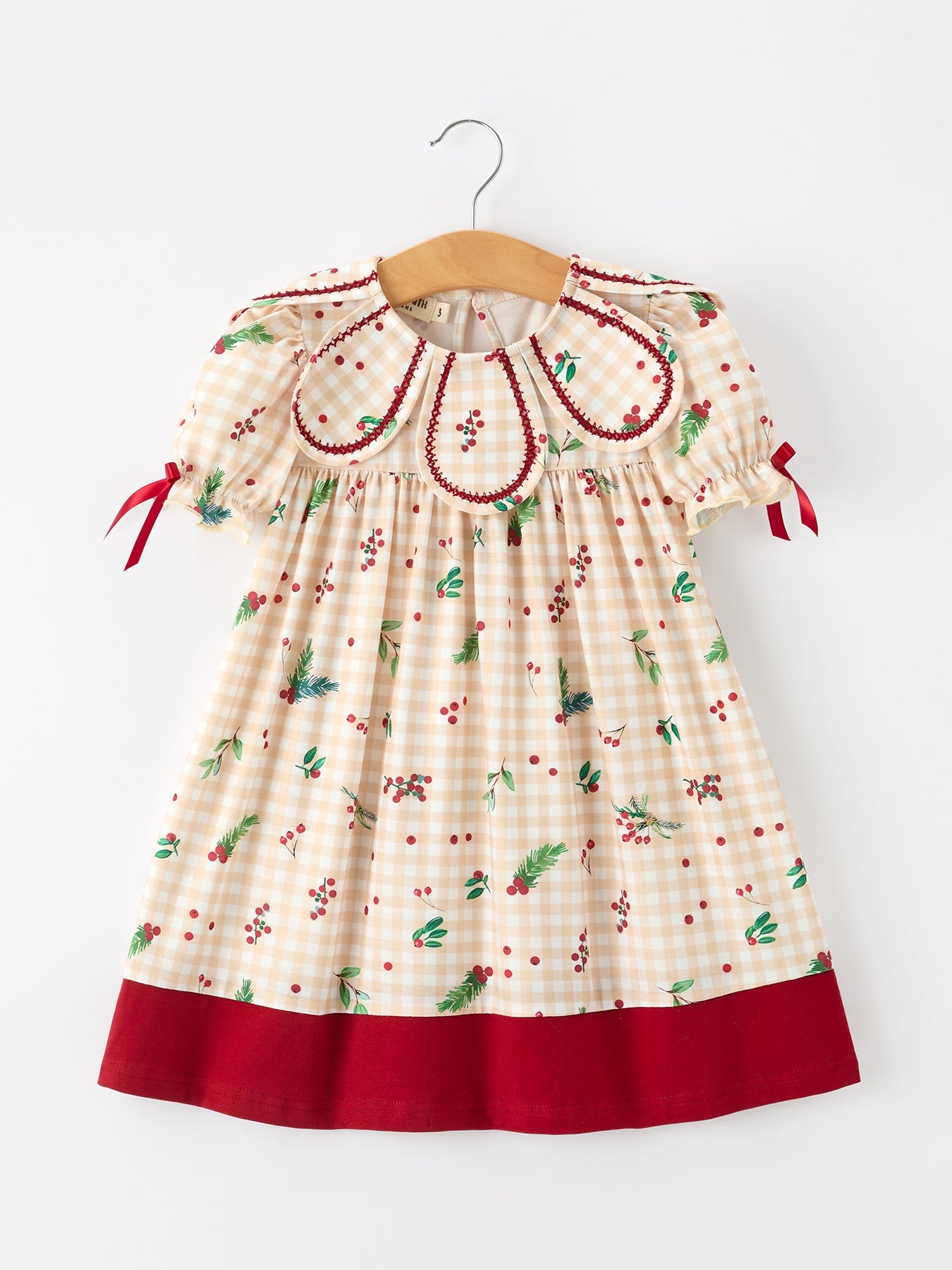 Girls dress in fall gingham print with a ruffle collar, berry and leaf accents, and a bow at the front.