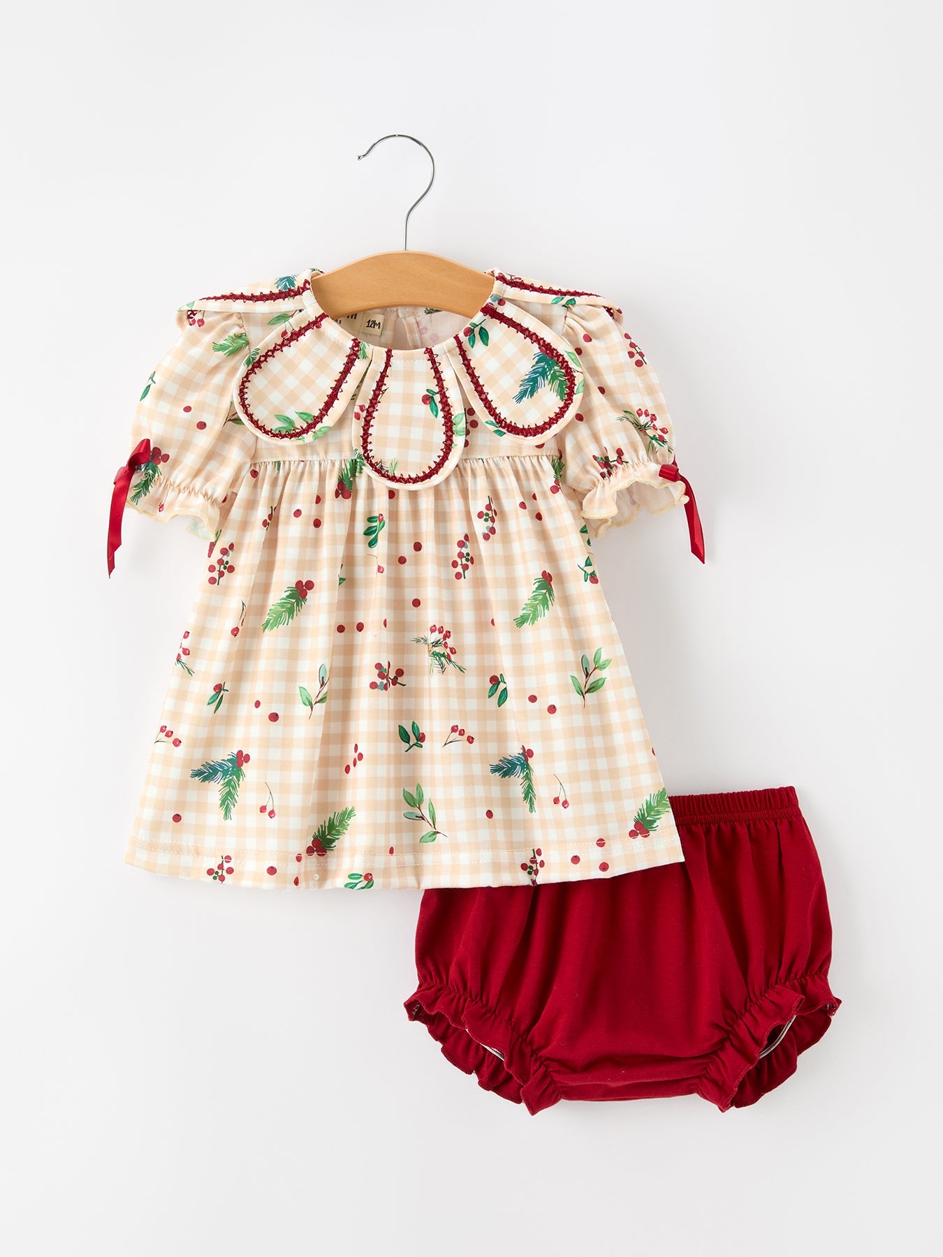 Baby bloomer set in fall gingham print with berry and leaf accents, a ruffle collar, and bow details.