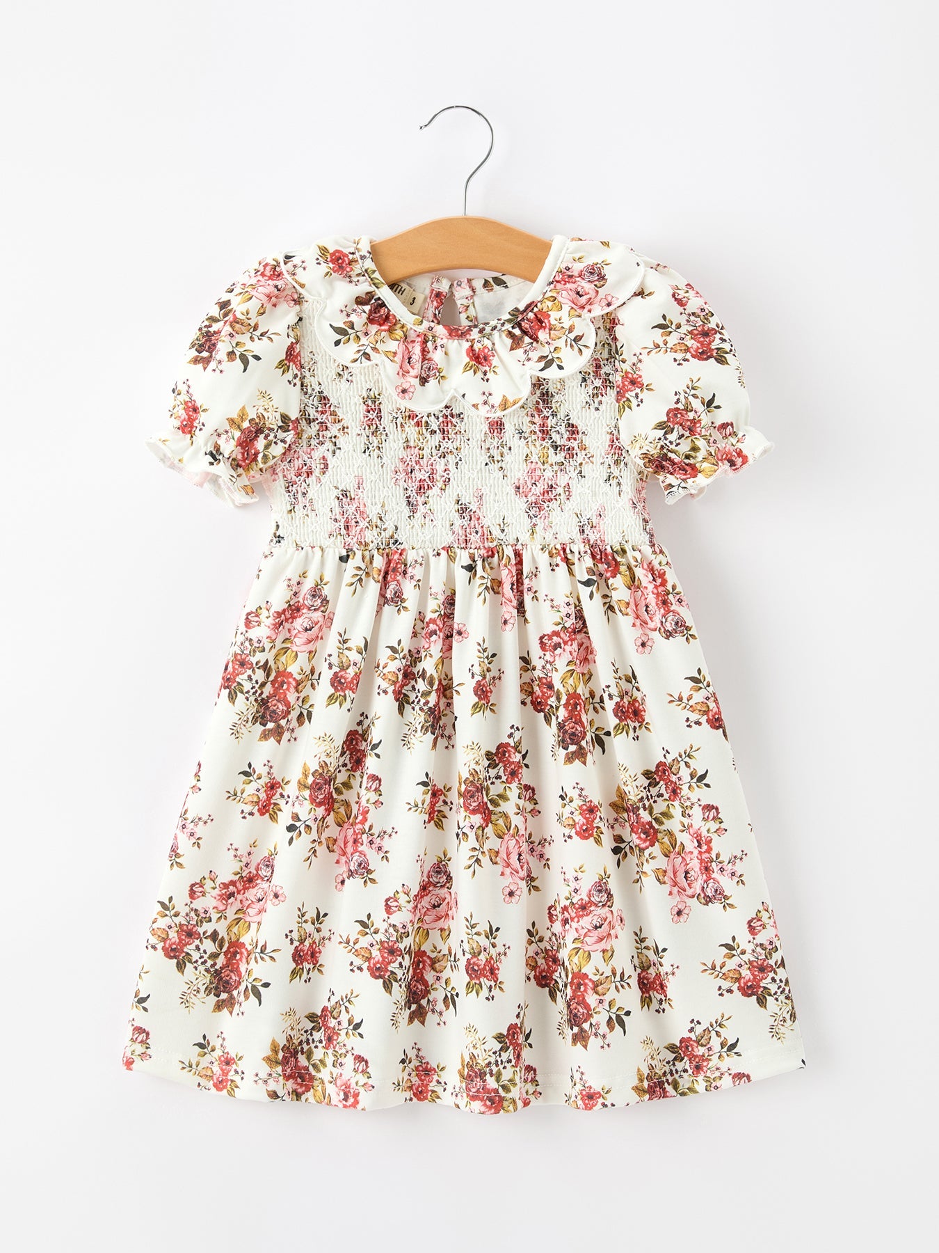 Girls' dress with an autumn floral print, pleated skirt, petal collar, and a bow accent at the waist.