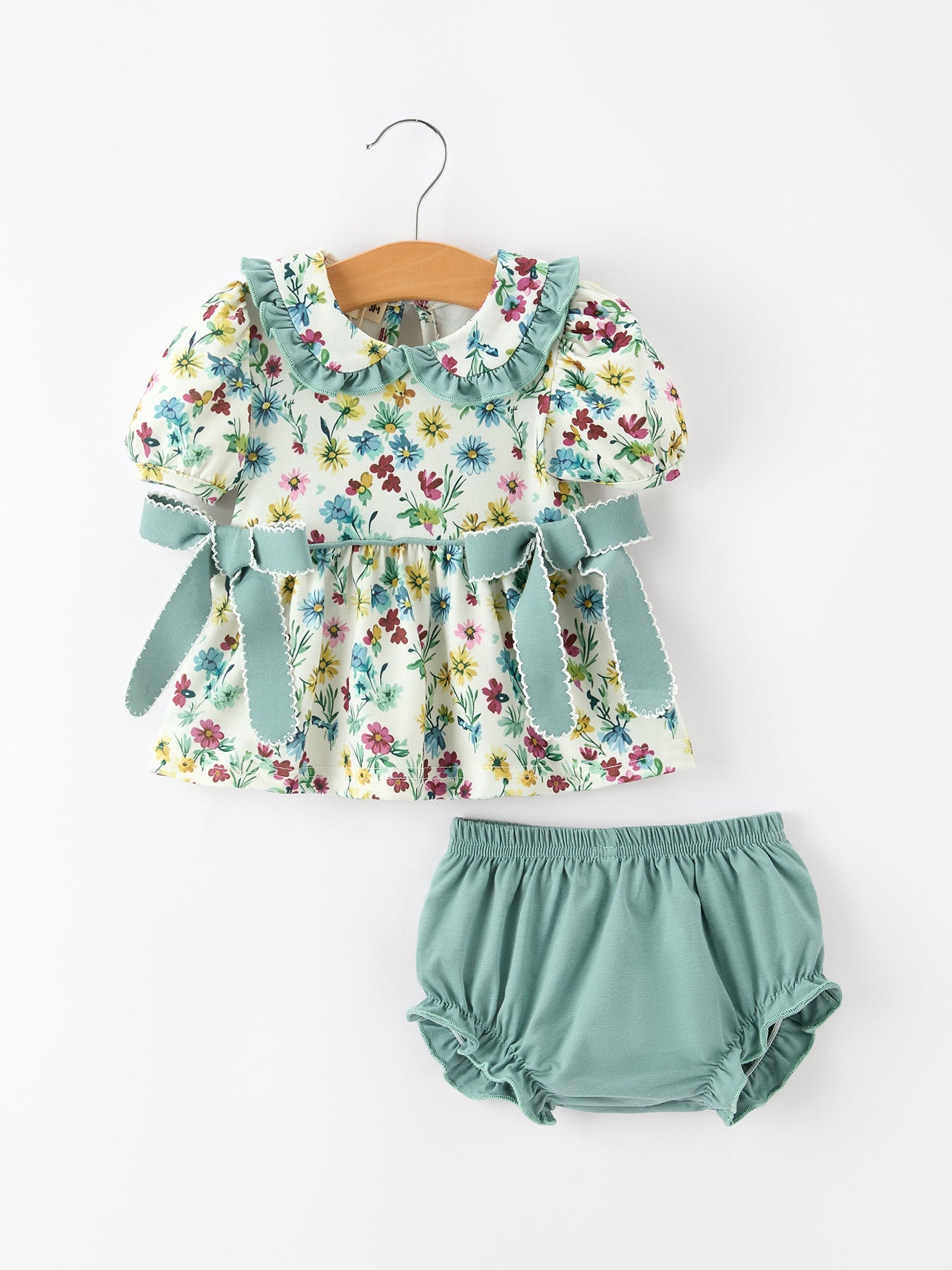 Girls two-piece set with green floral top, ruffled collar and side bows, plus solid green bloomers.