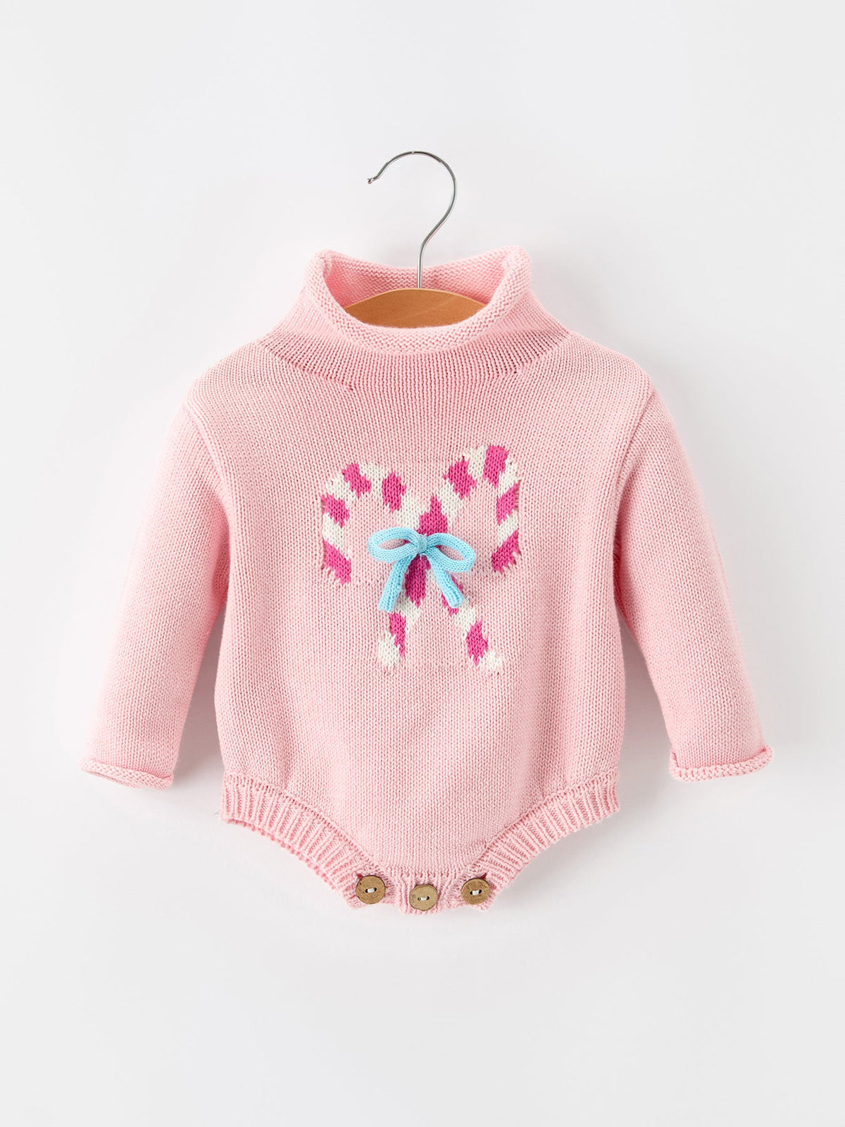 Baby girls knit romper with candy cane inspired design, bow detail at the neck, turtleneck collar and long sleeves