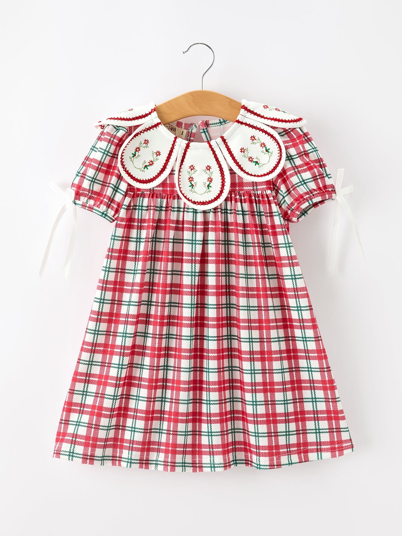 Baby girl dress in red and green Christmas plaid with an embroidered wreath collar and floral detailing