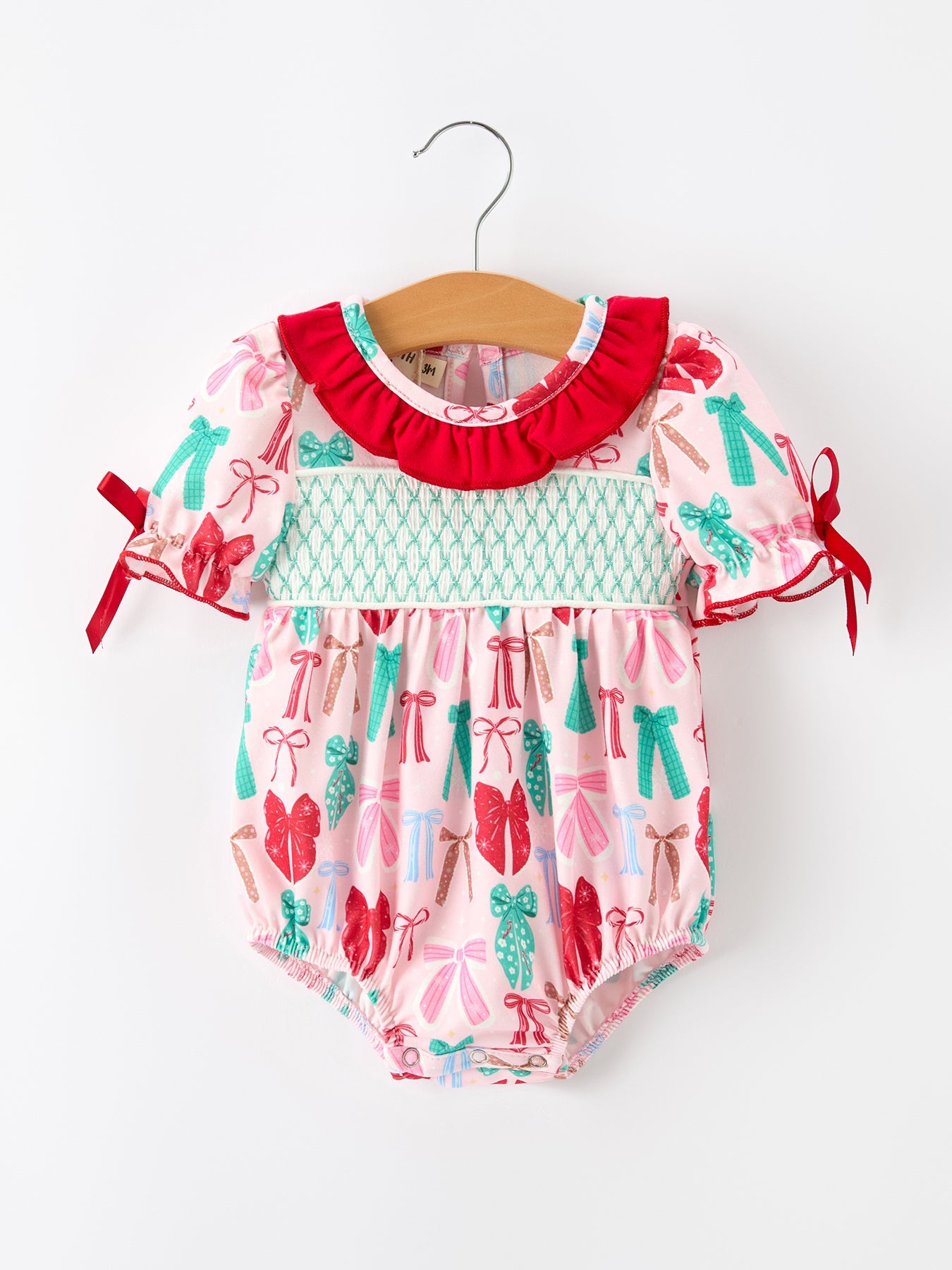 Baby girl bubble romper with smocked chest, red, green and pink Christmas bow print, ruffle collar and sleeve bows